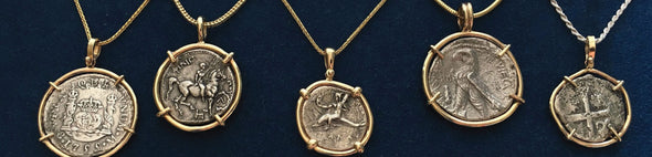 Row of ancient and treasure coin necklaces and pendant jewelry