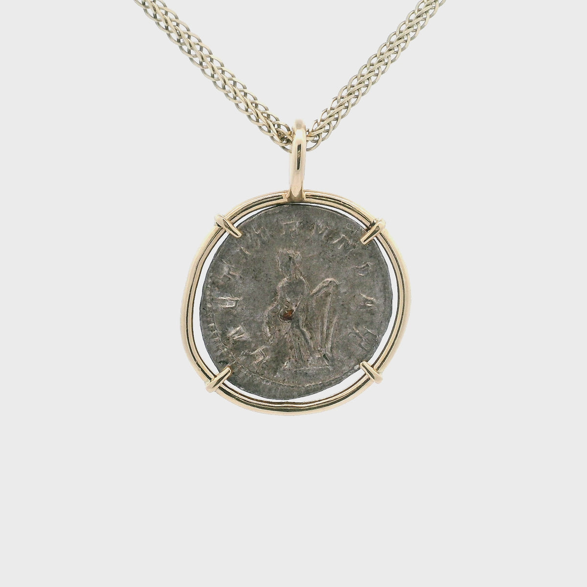 Rotating Silver Ancient Roman coin pendant set in 14K gold.