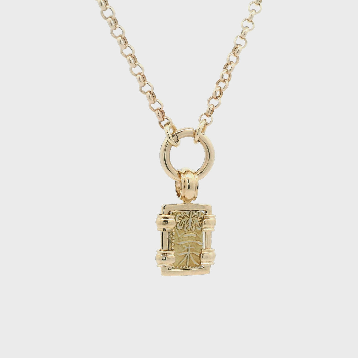 Rotating Gold rectangular Japanese Samurai-era coin pendant set in 18K gold.