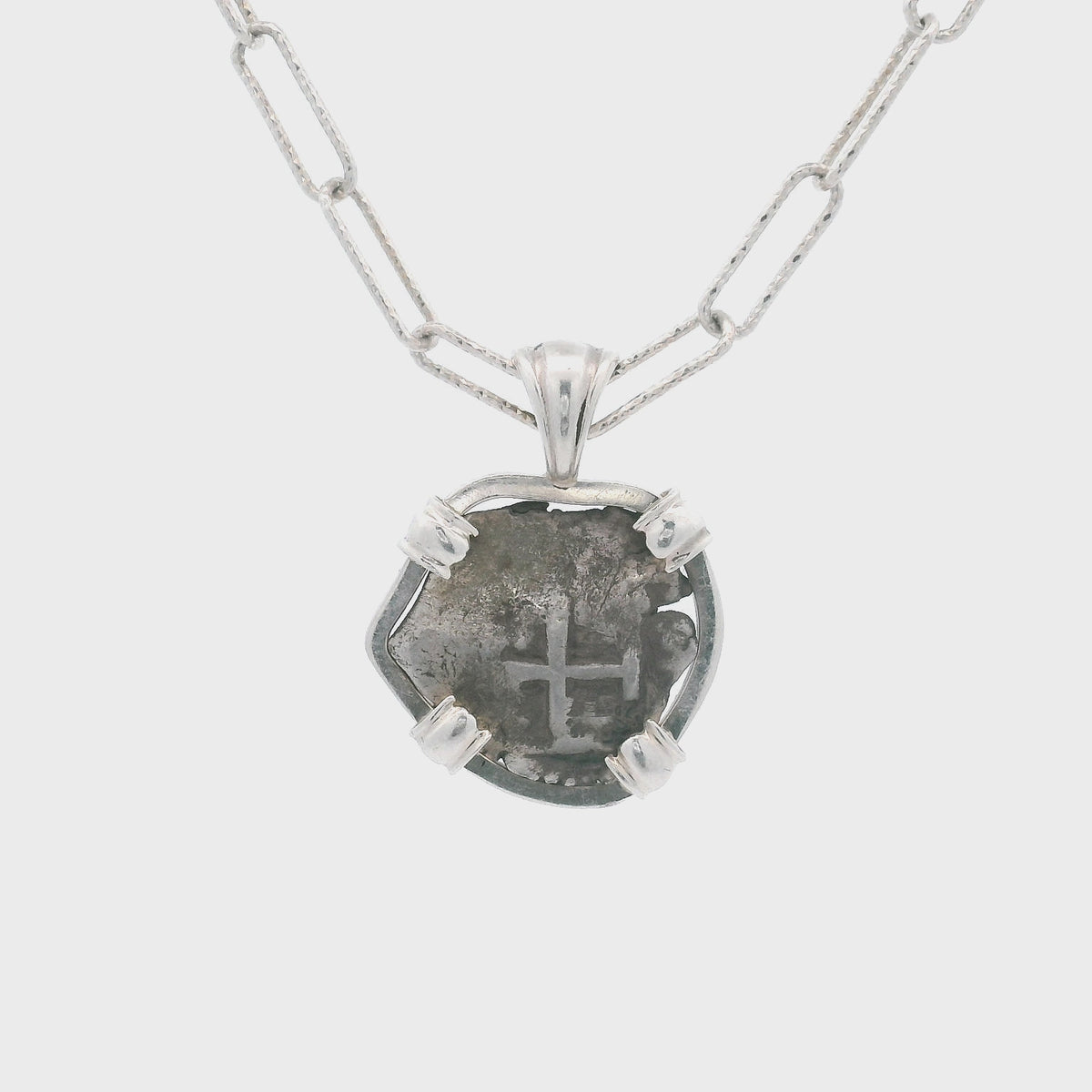 Rotating Silver Spanish coin pendant set in sterling silver.