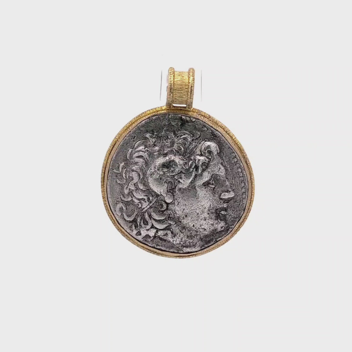 Rotating Silver Ancient Greek coin pendant set in 18K gold.