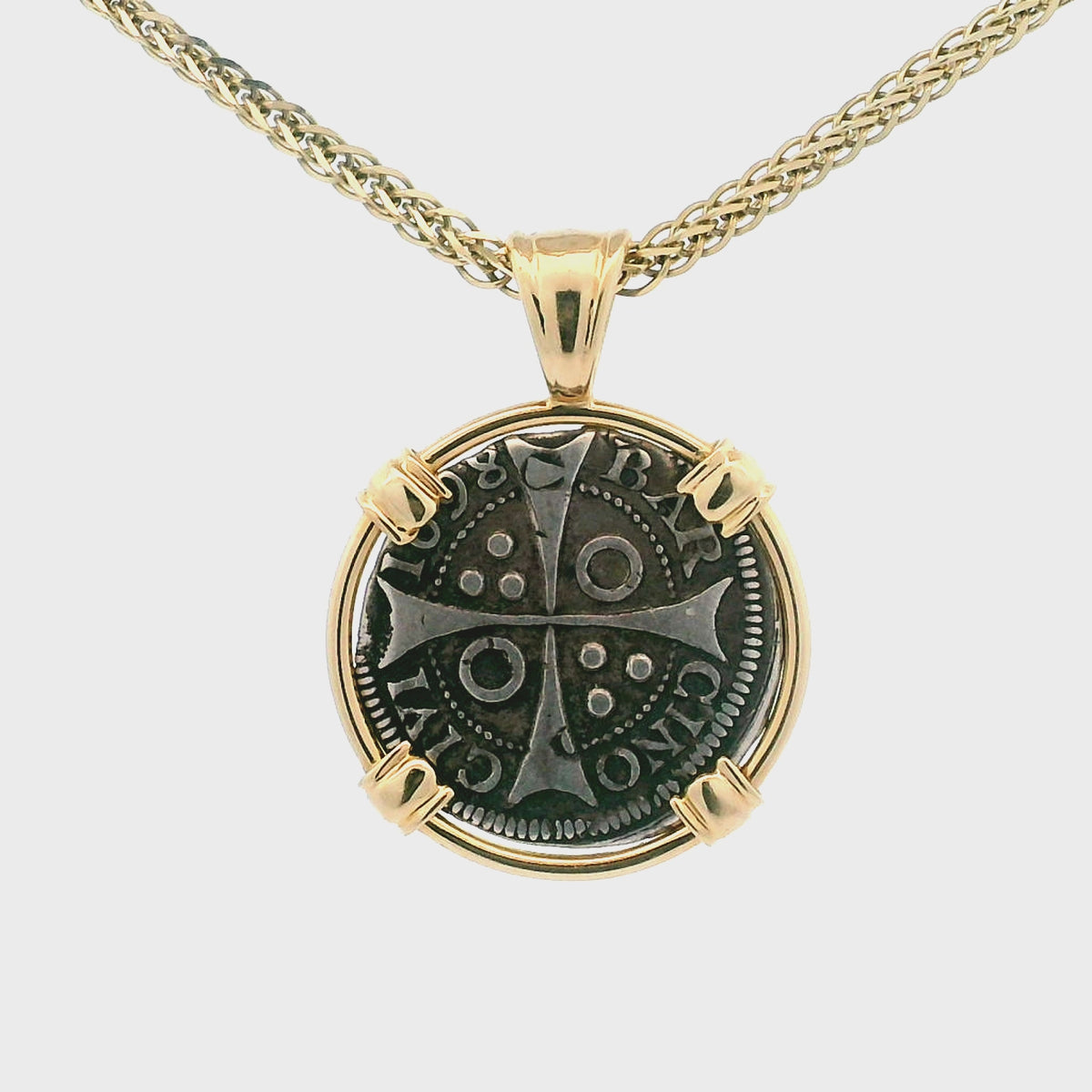 Rotating Silver Croat coin pendant set in 14K gold.
