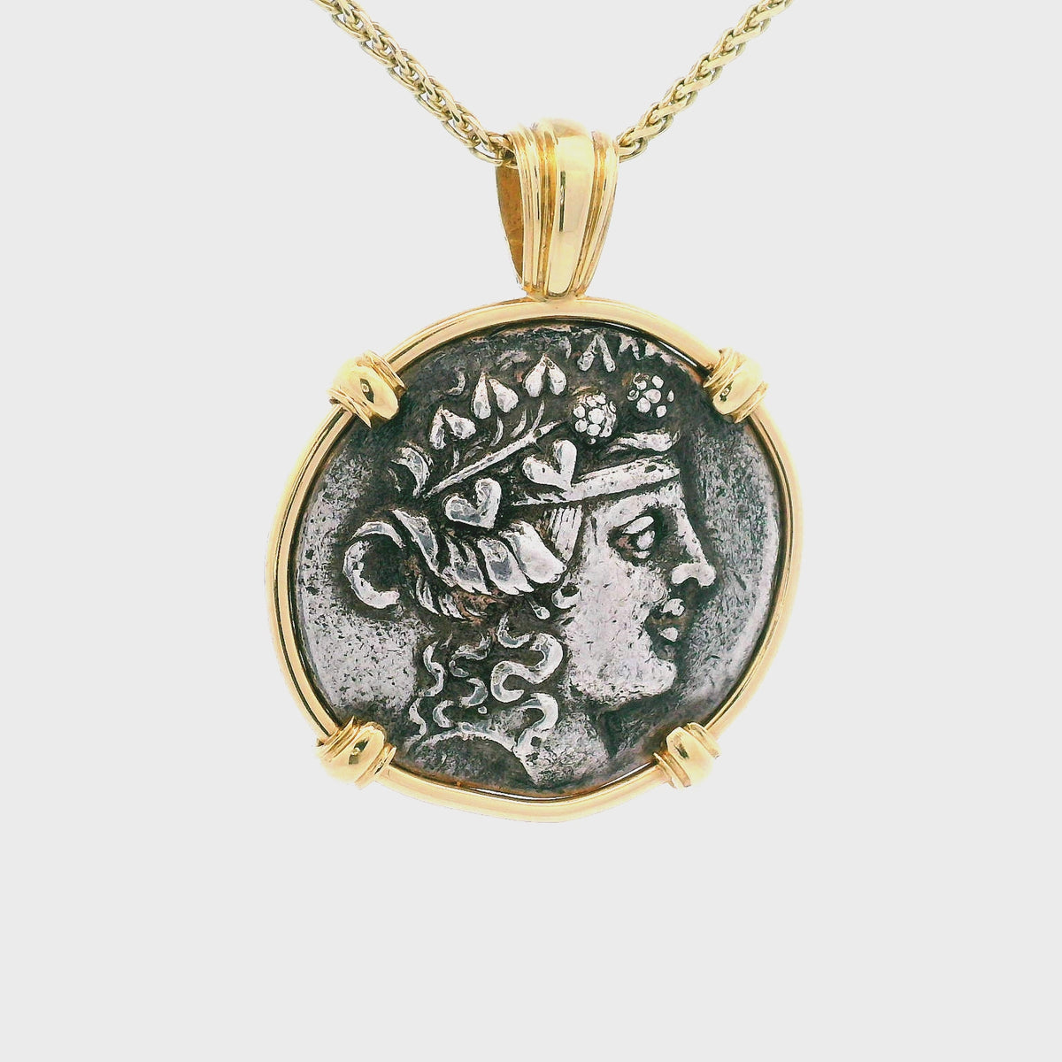 Rotating Gold Ancient Greek coin pendant set in 14K gold.