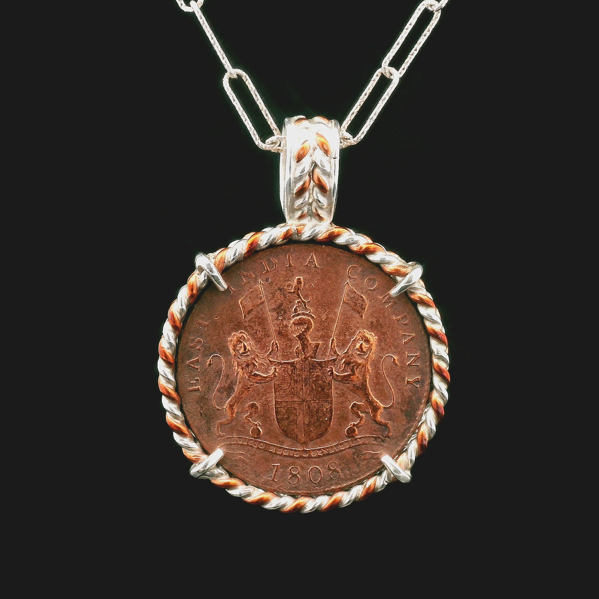 Rotating Shipwreck Copper coin pendant set in twisted copper and sterling silver.