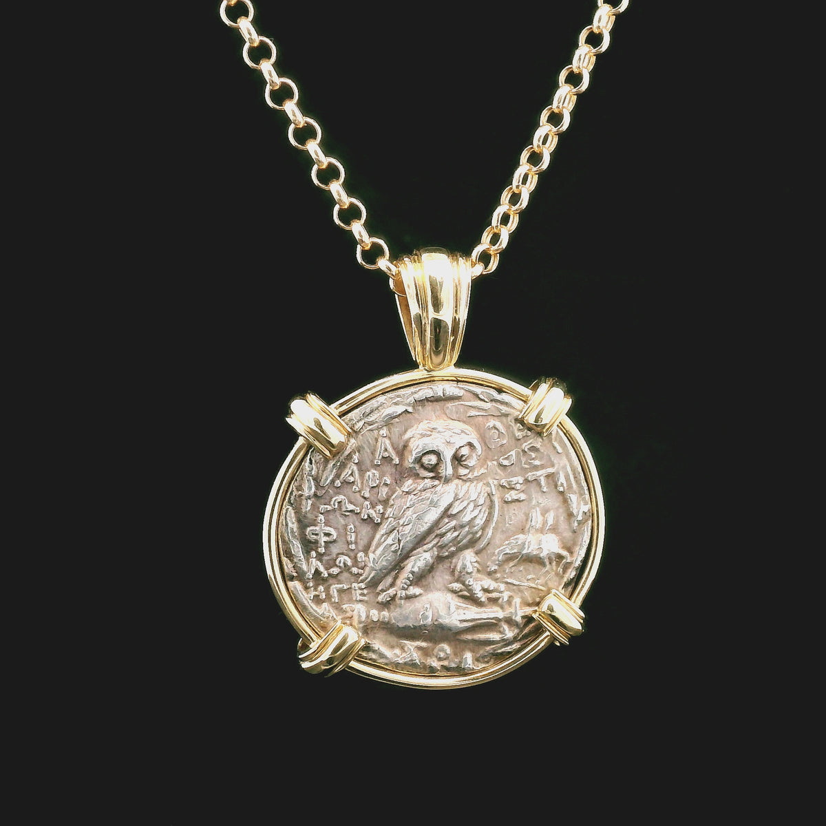 Rotating Silver Ancient Greek coin pendant set in 14K gold.