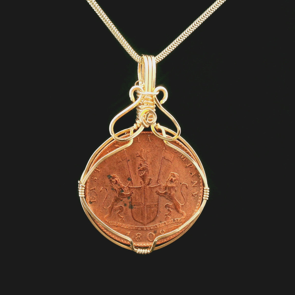 Rotating Shipwreck Copper coin pendant set in gold-filled wire.