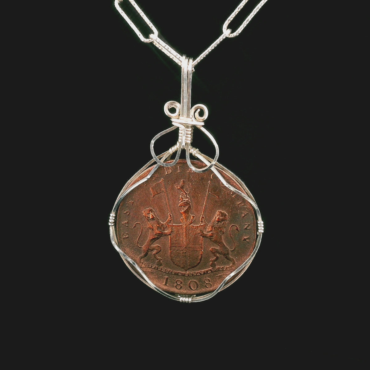 Rotating Shipwreck Copper coin pendant set in sterling silver wire.