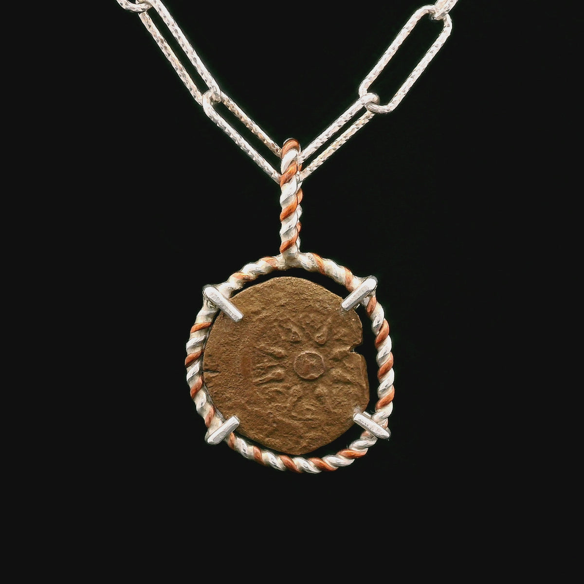 Rotating Bronze Widow’s Mite coin pendant set in twisted copper and sterling silver.