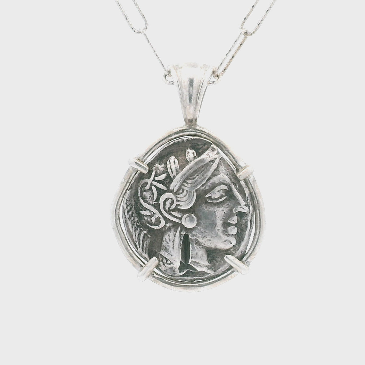Rotating Silver Ancient Greek coin pendant set in sterling silver.