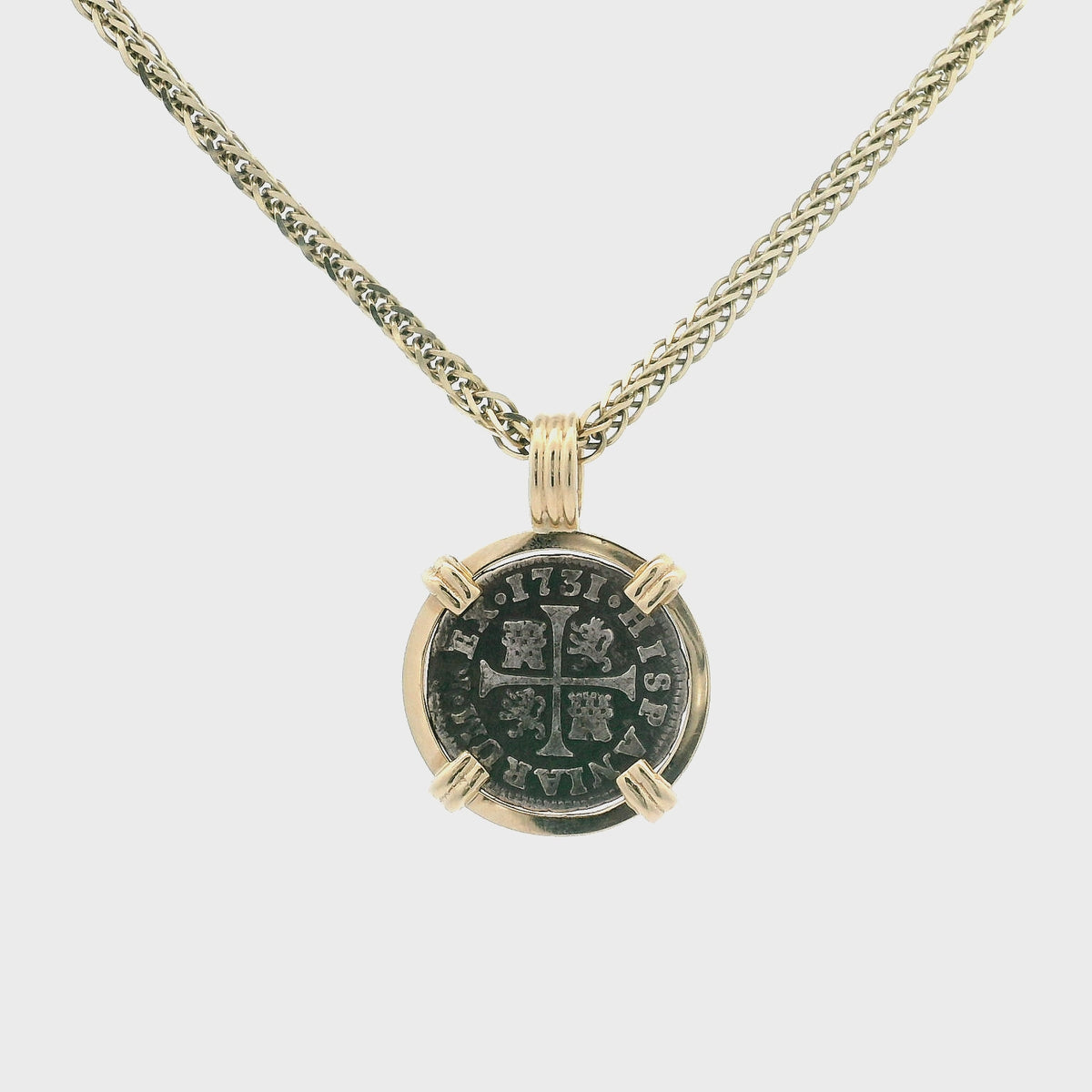 Rotating Silver Spanish coin pendant set in 14K gold.