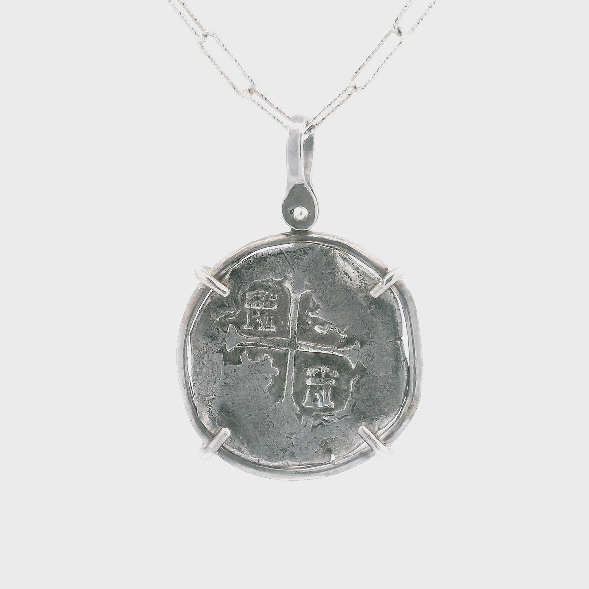 Rotating Silver Spanish coin pendant set in sterling silver.