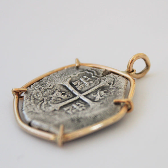 Side view of shipwreck coin pendant